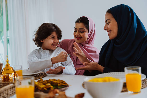 istock Muslim family members playing a game during eid celebration meal 2244729841