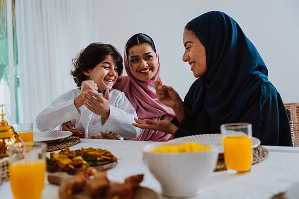 istock Muslim family members playing a game during eid celebration meal 2244729848