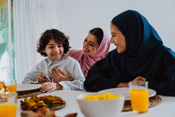 istock Muslim family members playing a game during eid celebration meal 2244729868