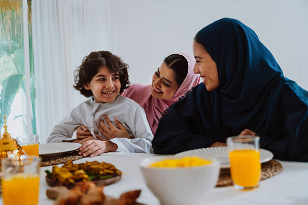 istock Muslim family members playing a game during eid celebration meal 2244729877