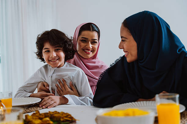 istock Muslim family members playing a game during eid celebration meal 2244729886
