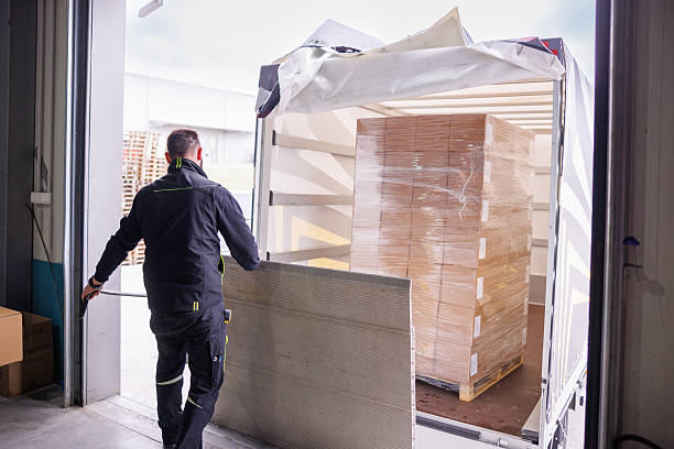 istock Man on the loading dock lifting ramp after loading the truck with goods on pallet 2244732108