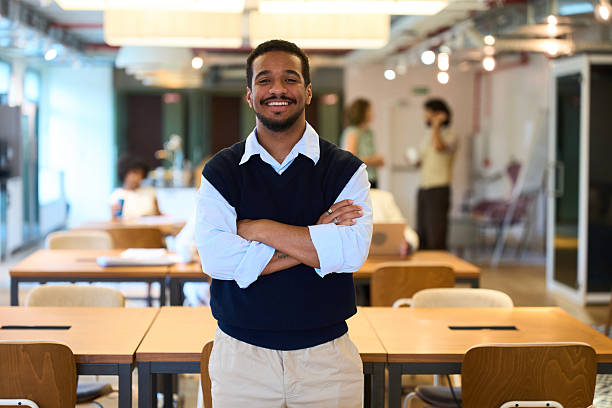 istock Confident businessman standing with arms crossed in modern office 2244737150