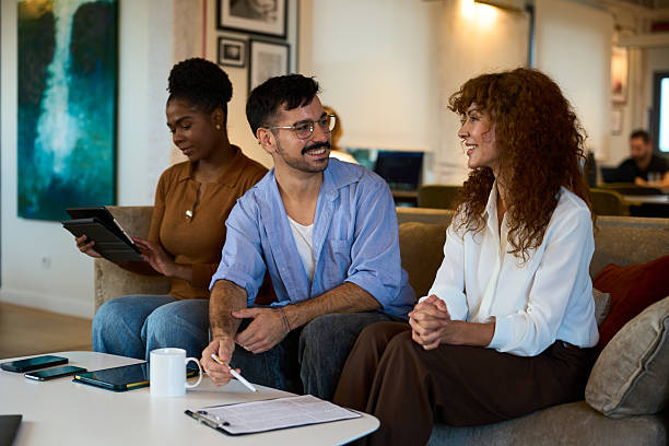 istock Diverse business colleagues collaborating during meeting in modern office lounge 2244737279