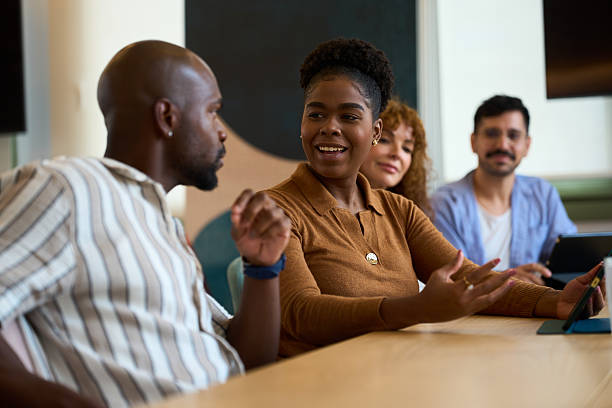 istock Diverse business team collaborating in an informal office discussion 2244737303