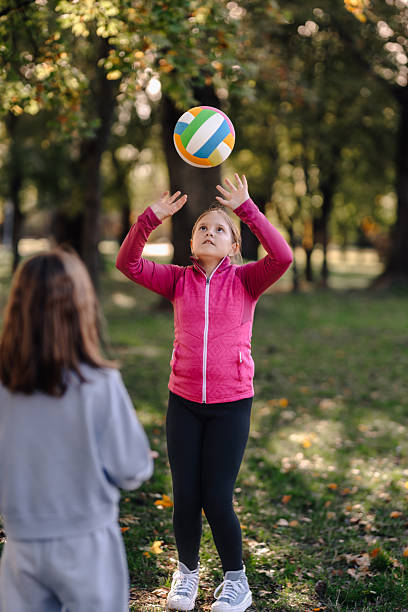 istock Girls playing volleyball outdoors having active fun 2244737374