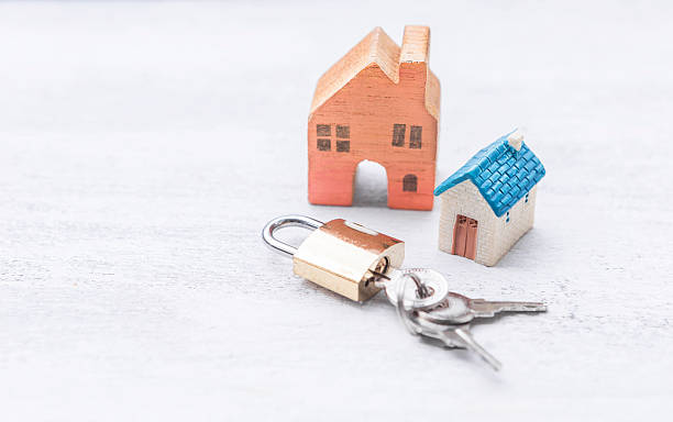 istock Miniature house with keypad on white wood background 2244738087