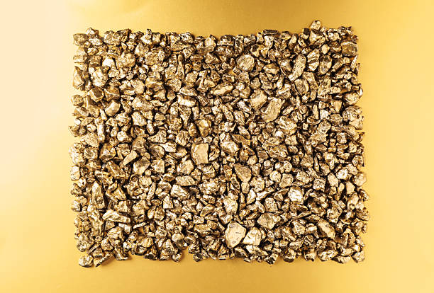 Gold nuggets on shiny background, top view