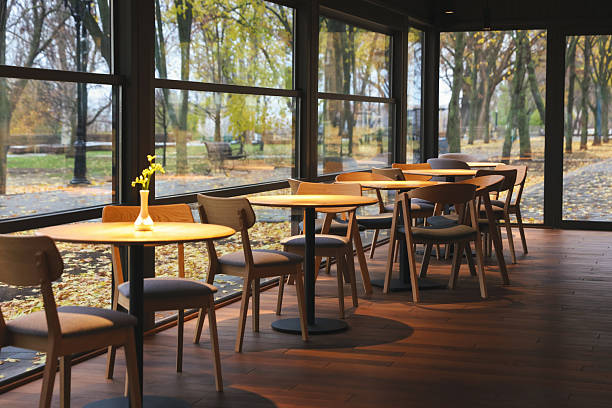 Stylish restaurant with large windows and comfortable furniture. Interior design