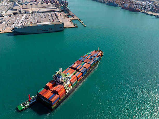 istock containers ship sailed into commercial port for load and unloading cargo from container ship for import export by crane for distributing goods by trailers transported to customers and dealers, 2244740540