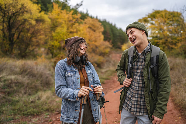 istock Young couple hiking trail, sharing laughter in autumn forest 2244741055
