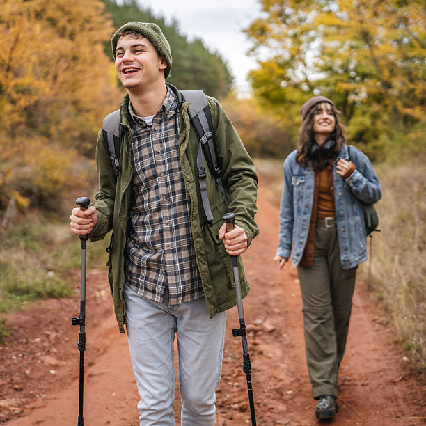 istock Smiling couple hiking forest trail during autumn 2244741530