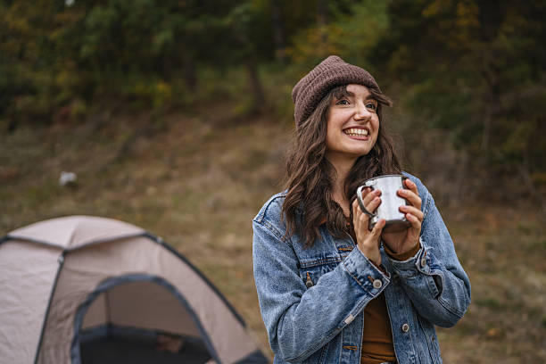 istock Woman enjoying warm drink while camping in autumn nature 2244742641