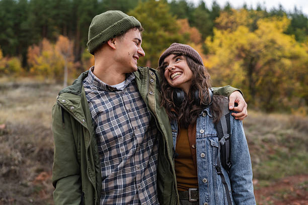 istock Young couple enjoying autumn hike, guy pointing finger 2244742704