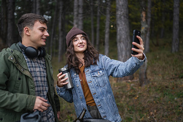 istock Happy young couple posing for self portrait in forest 2244743140
