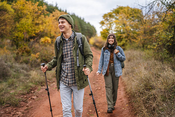 istock Smiling couple hiking forest trail during autumn 2244743142