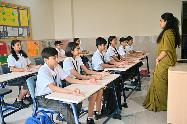 istock Schoolchildren practicing classroom meditation with teacher 2244743625