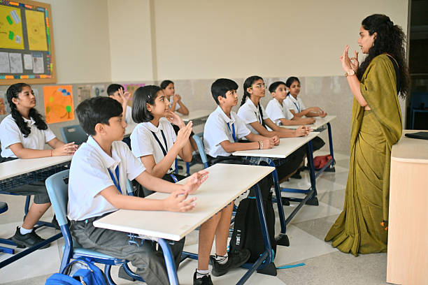istock Teacher guiding students through mindfulness hand-breathing exercise in classroom 2244743627