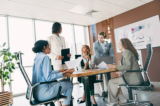istock Team of diverse professionals collaborating in modern office workspace for business project planning and progress analysis 2244743849
