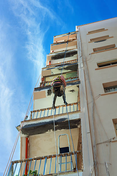 istock A worker repairs an apartment building. 2244745268