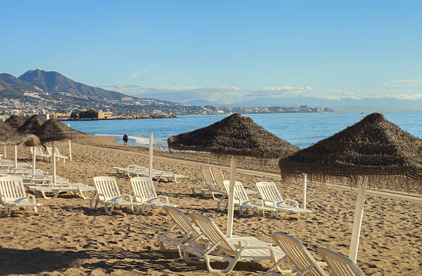 Malaga, Spain - September 29, 2022: People enjoy a sunny afternoon at the beach in Malaga, Spain.
