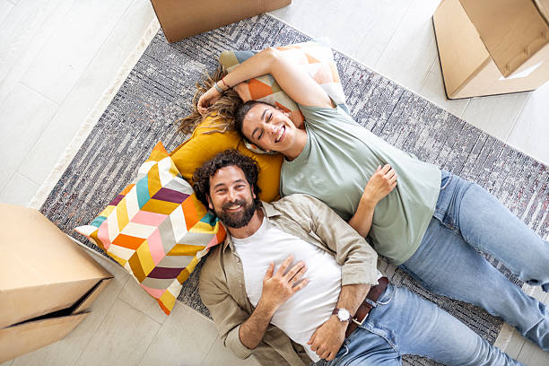 istock Smiling Man and Woman Relaxing Together During Moving Day 2244746252