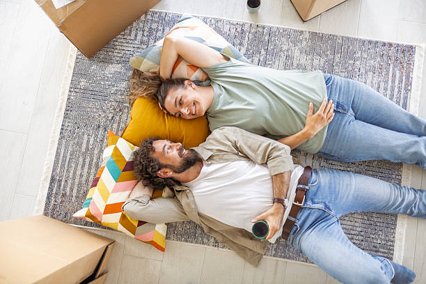 istock Happy Couple Enjoying Break from Moving and Laughing Together 2244746267