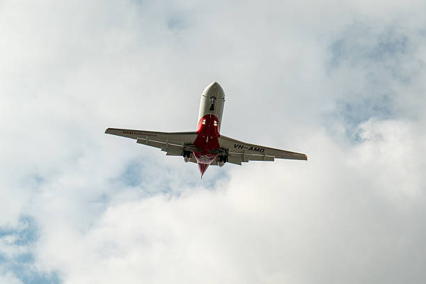 A NSW Ambulance Service Pilatus PC-24 plane, registration VH-AMD, landing at Sydney Kingsford Smith Airport as flight AM297 from Wagga Wagga. This image was taken from Airport Drive, Mascot on a hot, sunny and partly cloudy afternoon on 1 November 2025.