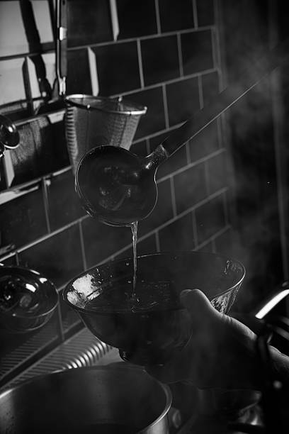 istock Chef pouring broth into a plate for cooking ramen 2244753743