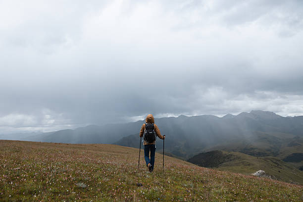 istock Woman backpacker hiking on high altitude mountains top 2244753812