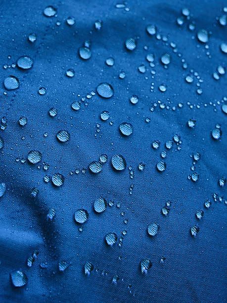 istock Water droplets on blue fiber waterproof fabric. Blue background. 2244753956