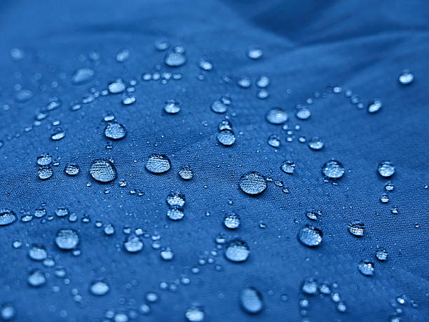 istock Water droplets on blue fiber waterproof fabric. Blue background. 2244753958