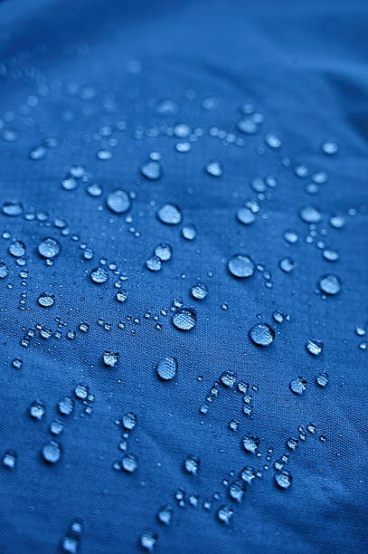 istock Water droplets on blue fiber waterproof fabric. Blue background. 2244753973