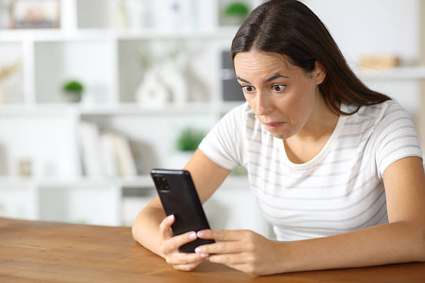 istock Perplexed woman checking absurd content on phone 2244754464
