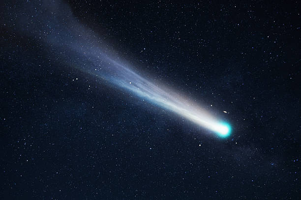istock Comet 2025 in space. Celestial body flying through the deep cosmos. Bright comet streaking through a dark, star-filled night sky. Stunning view of a luminous comet with a long tail in deep space. 2244755395