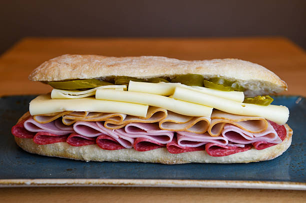 Delicious  Sandwich with Salami, Ham, Turkey, Cheese, and Pickles