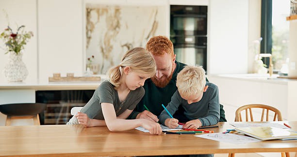 istock Father, children or drawing in home for creative activity, skill development and family bonding together. Dad, kids and color in picture with pencil for learning art, knowledge and education support. 2244759263