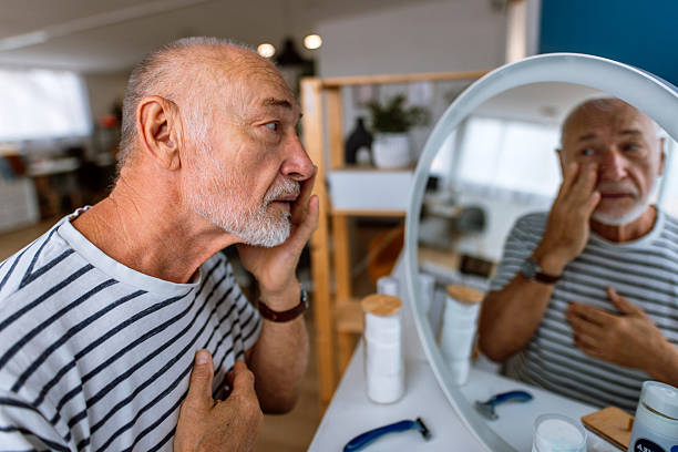 istock Handsome Senior Man Applying Cream at His Face in the Bathroom 2244759872