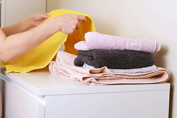 istock Warm home atmosphere with woman folding towe 2244760846