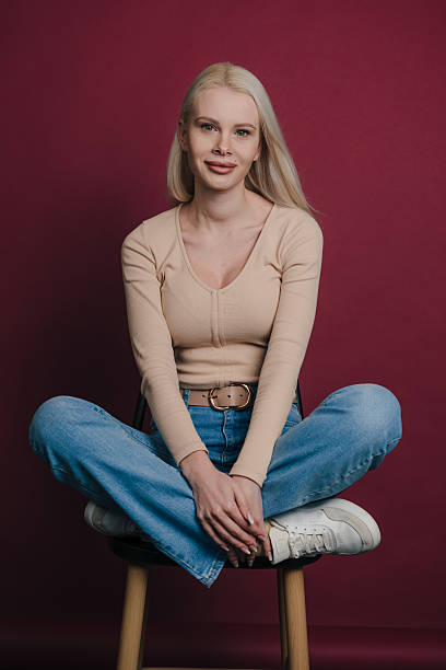 istock Gentle young woman seated peacefully with thoughtful expression 2244761530
