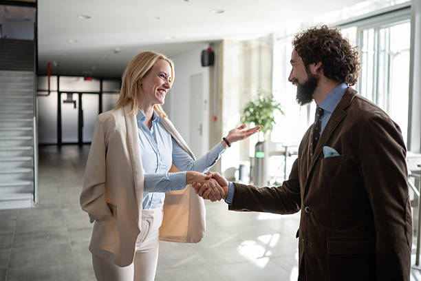 istock Business colleagues shaking hands making agreement in office corridor 2244763995