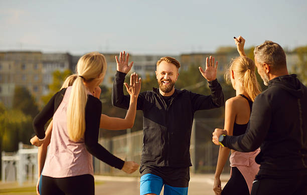 istock Sporty Friends Exchange High Five During Park Workout 2244764060