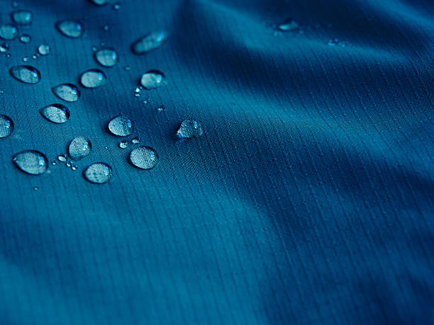 istock Water droplets on blue fiber waterproof fabric. Blue background. 2244767006