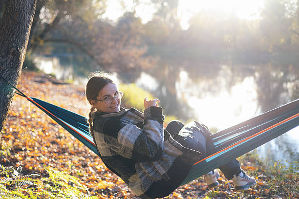 istock Lakeside hammock camp under tall trees at sunset – stock photo 2244767482