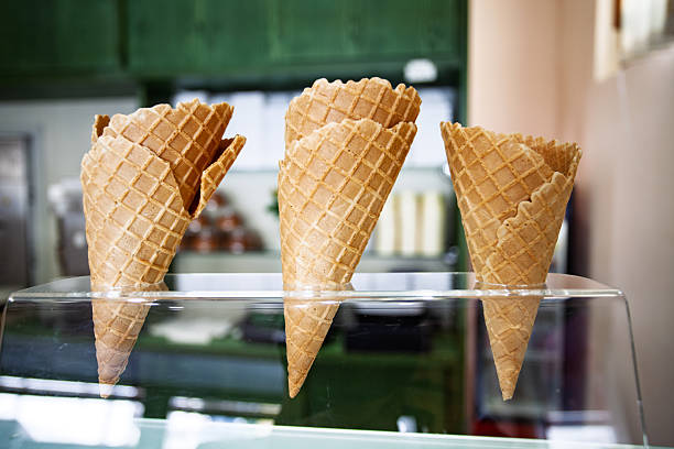 Tasty ice creams in hands. Blurred background of summer city cafe.