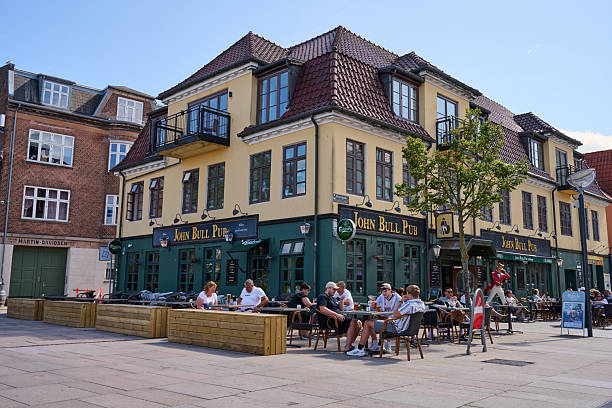 People enjoy a warm summer day by hanging out on the pub a having a beer