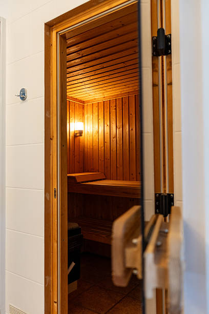 istock Traditional wooden sauna interior with warm light and benches 2244767855