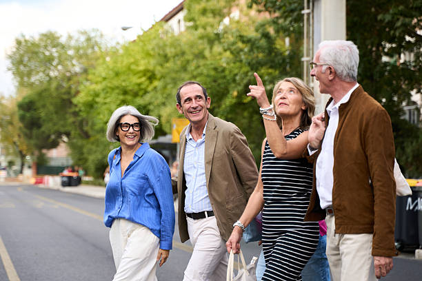 istock Seniors sightseeing on urban street pointing upwards 2244767978