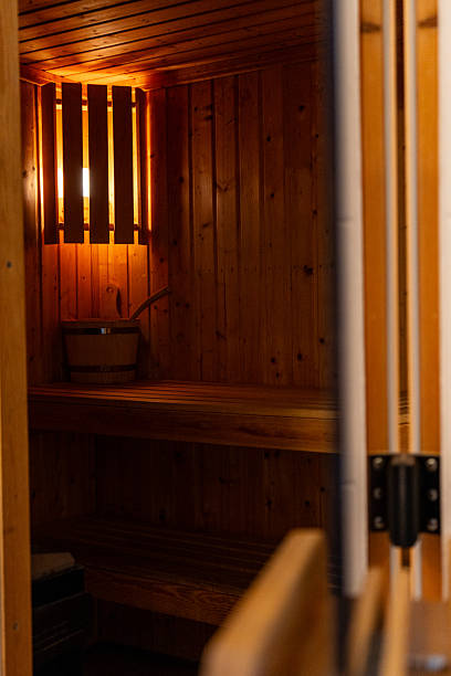 istock Traditional wooden sauna interior with warm light and benches 2244768519