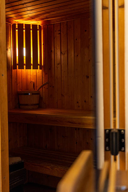 istock Traditional wooden sauna interior with warm light and benches 2244768560